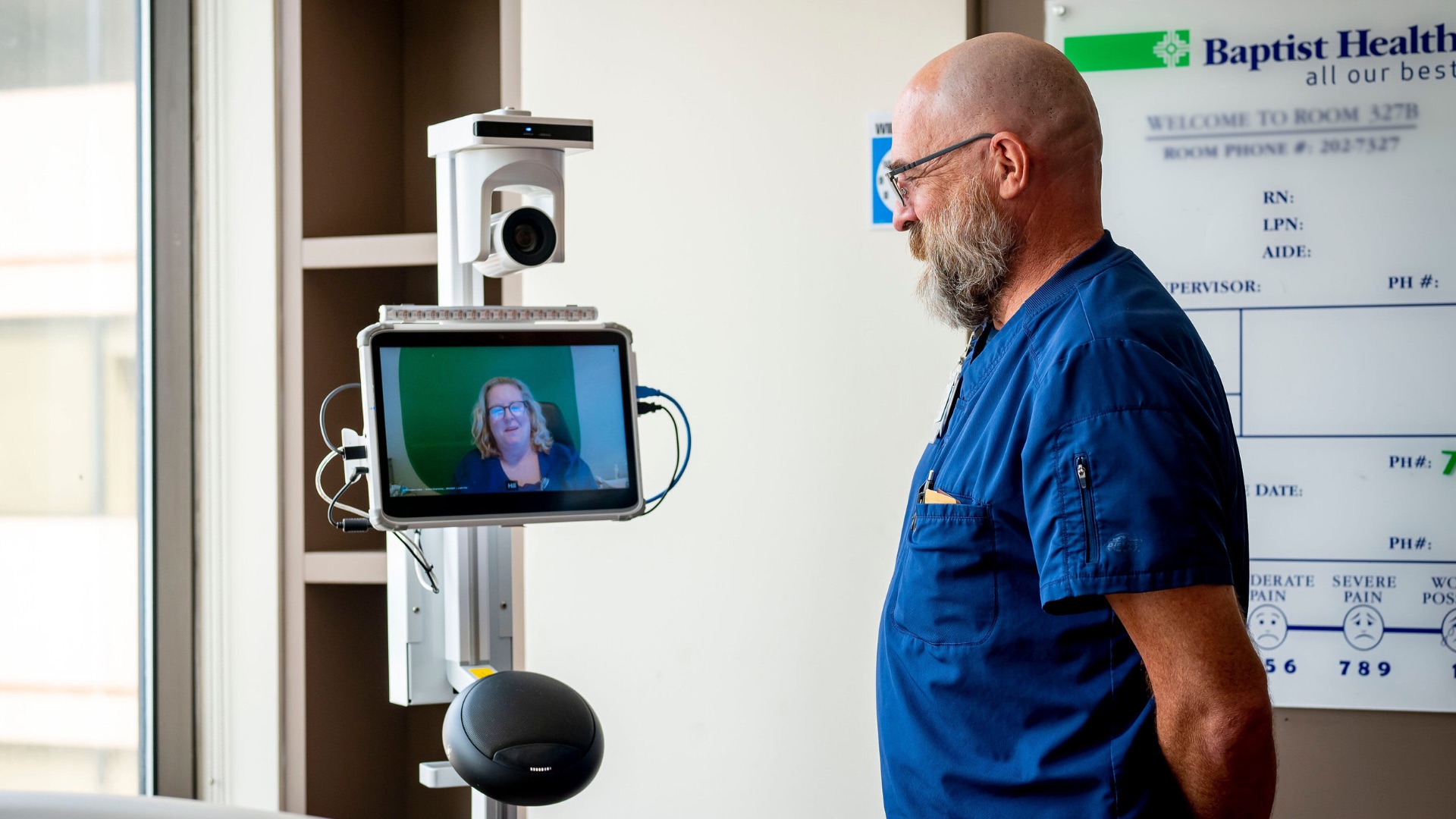 Provider speaking to patient via telehealth device